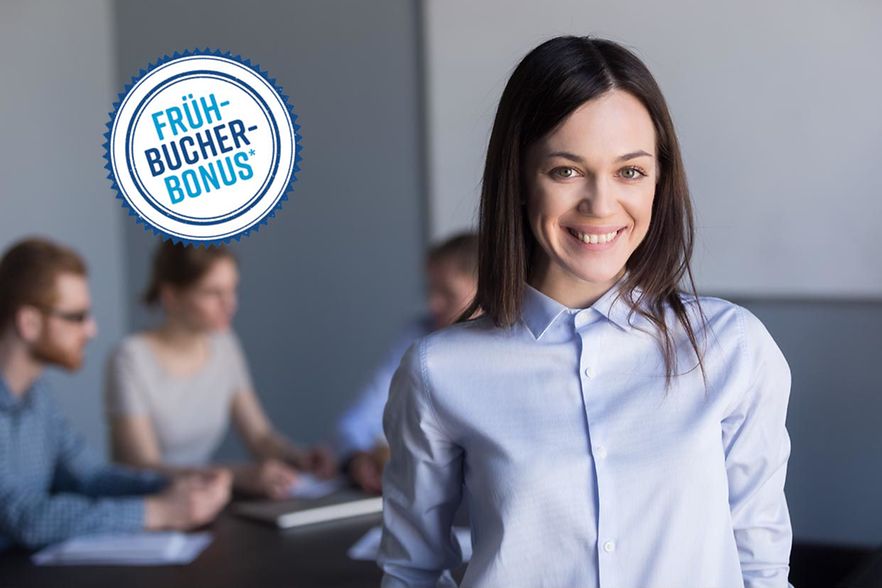 Portrait,Of,Smiling,Female,Employee,Looking,At,Camera,During,Office